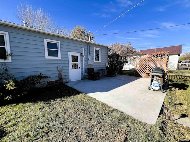 back of property featuring a lawn and a patio