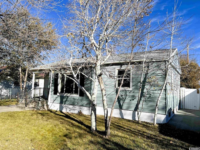 view of side of home with a lawn