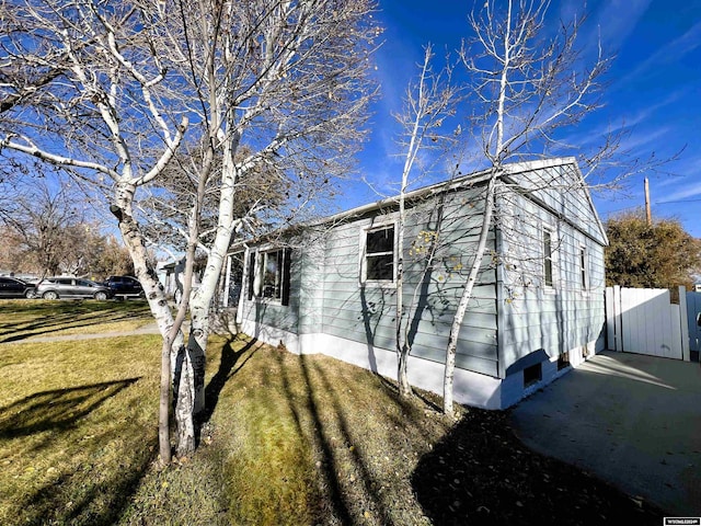 view of side of property with a yard