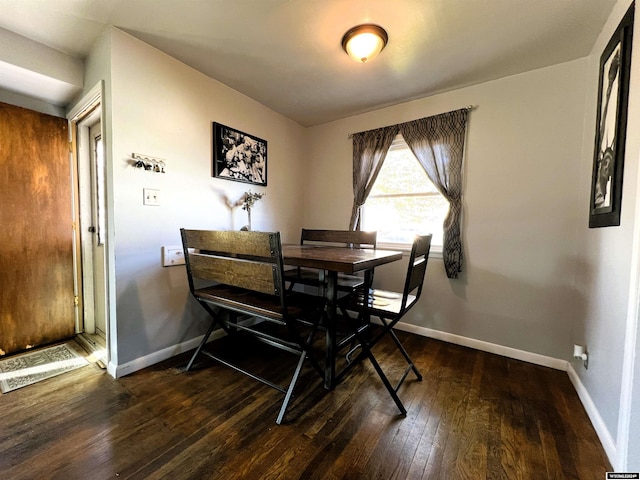 dining space featuring dark wood-type flooring