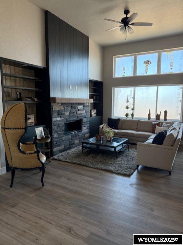 3698 Red Wolf Dr, Casper, WY 82604 - living area featuring wood finished floors, ceiling fan, and a fireplace