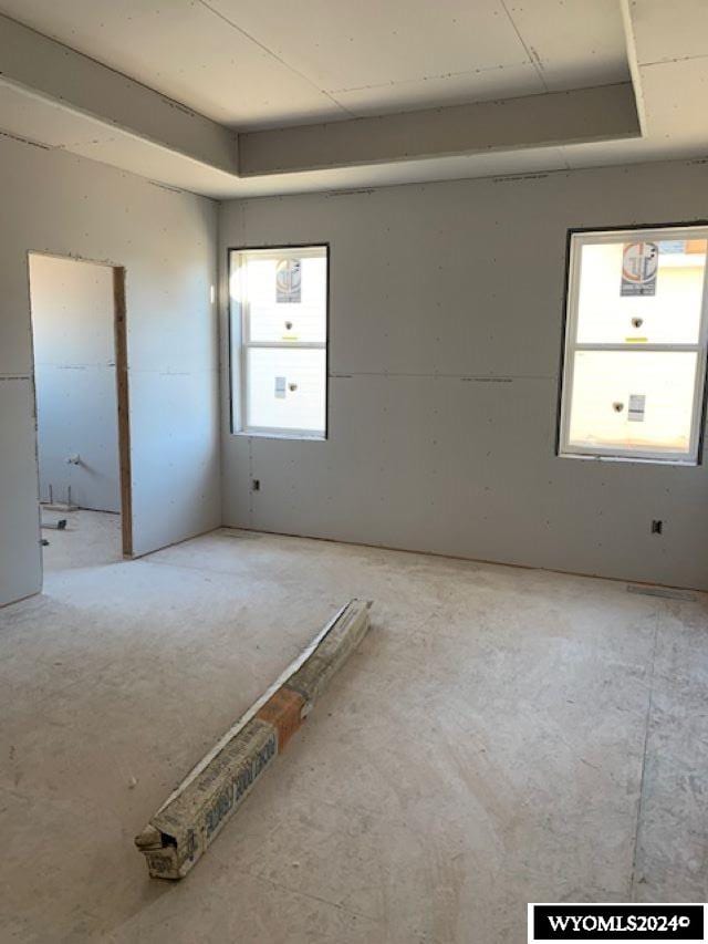 empty room featuring a raised ceiling