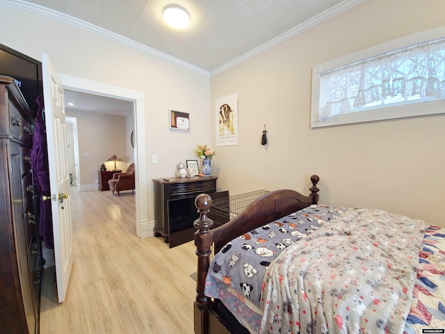 bedroom featuring light hardwood / wood-style flooring and crown molding