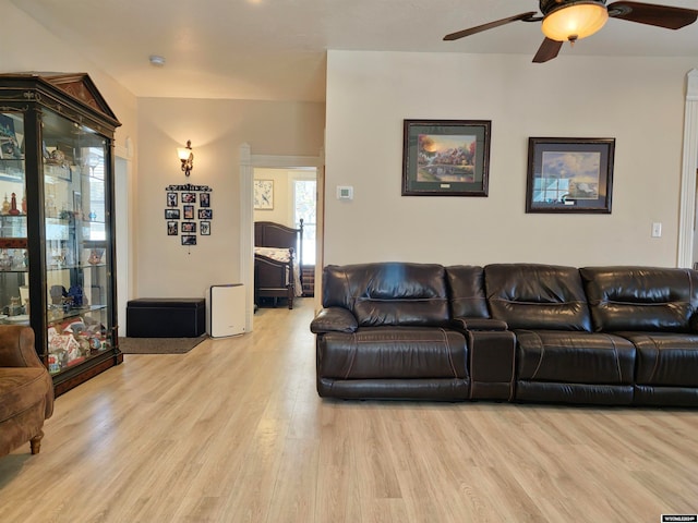 living room with ceiling fan and light hardwood / wood-style flooring