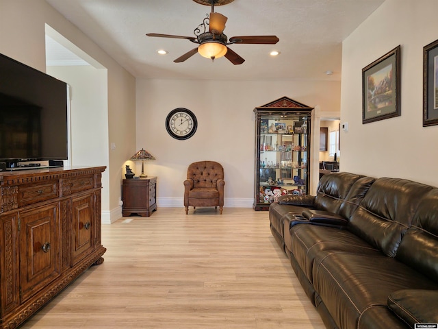 living room featuring ceiling fan and light hardwood / wood-style flooring