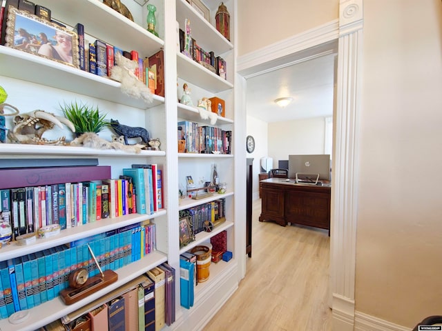 corridor with light hardwood / wood-style floors