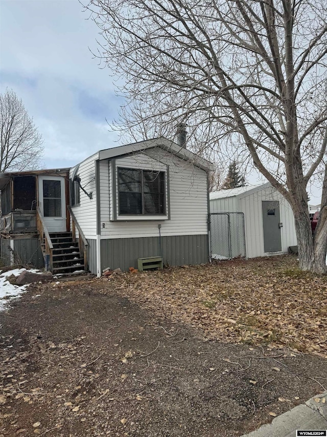 view of side of home with a storage shed