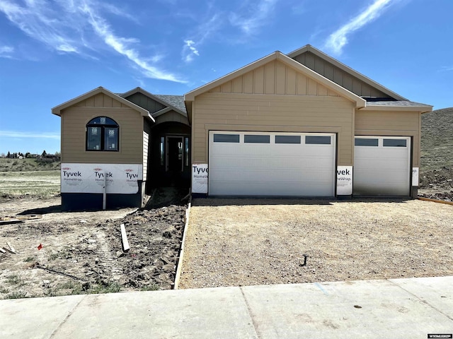 4921 Tranquility Way, Casper, WY 82601 - view of front of home featuring an attached garage, board and batten siding, and driveway