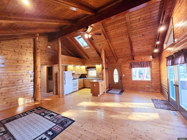 unfurnished living room with wood walls, ceiling fan, light hardwood / wood-style floors, and wood ceiling