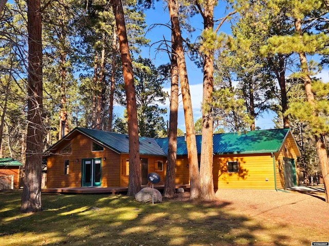 log-style house with a front lawn