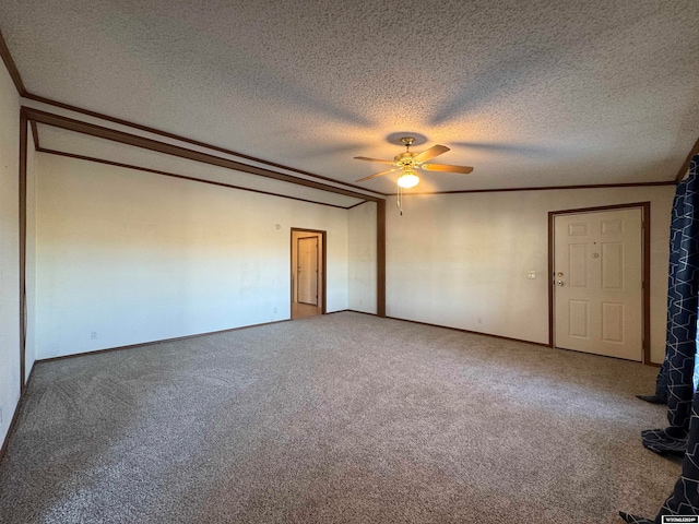 carpeted empty room featuring ceiling fan, crown molding, and a textured ceiling