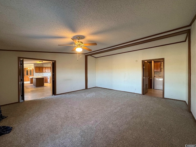 unfurnished bedroom featuring a textured ceiling, washer / clothes dryer, and light carpet