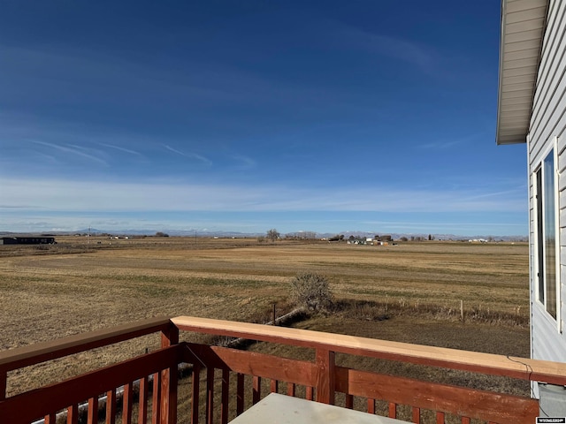 view of yard featuring a rural view and a balcony