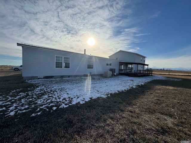 snow covered house featuring a deck and central air condition unit