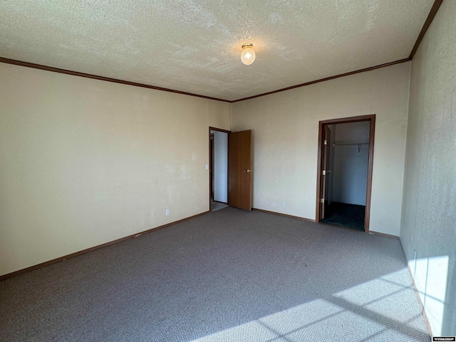 unfurnished bedroom with carpet flooring, a textured ceiling, and a closet