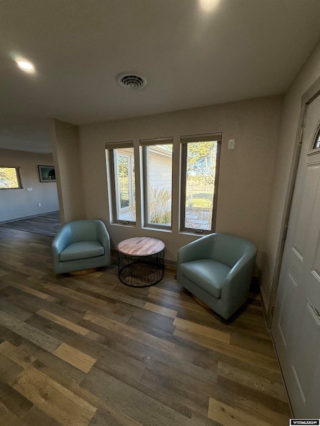 sitting room with dark wood-type flooring