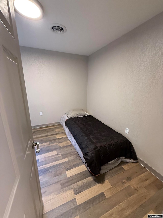 unfurnished bedroom with hardwood / wood-style floors