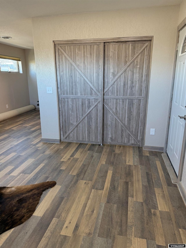 unfurnished bedroom featuring dark wood-type flooring