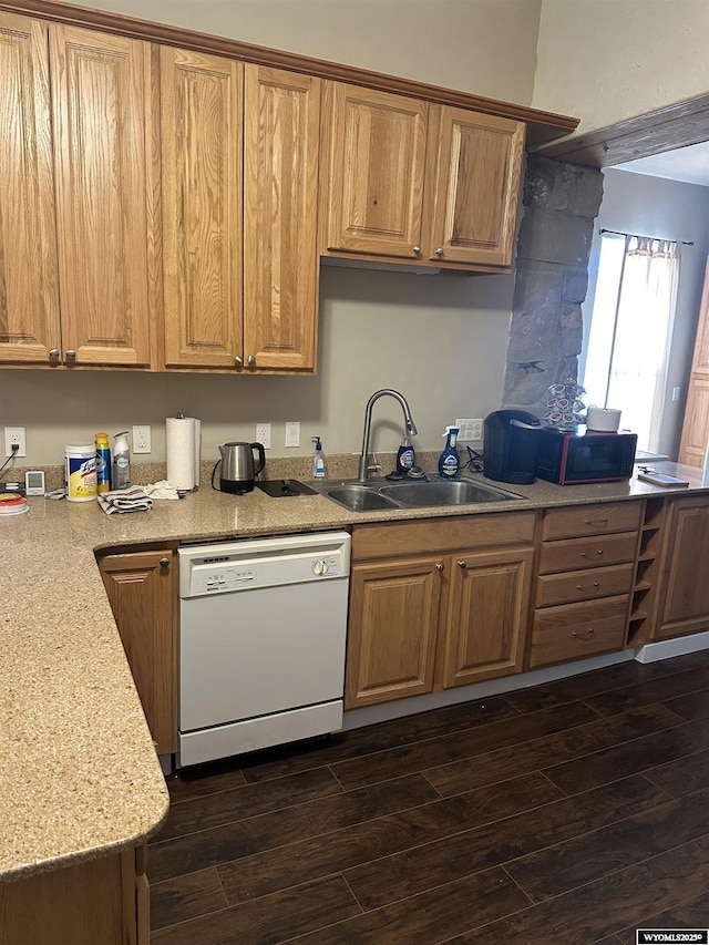 kitchen with white dishwasher, dark wood-style floors, light countertops, and a sink