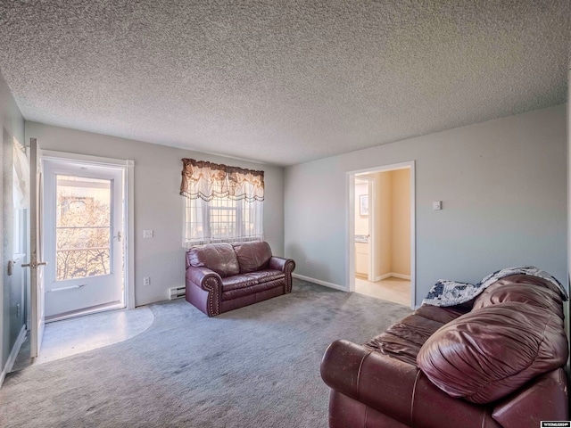 carpeted living room with a baseboard heating unit and a textured ceiling