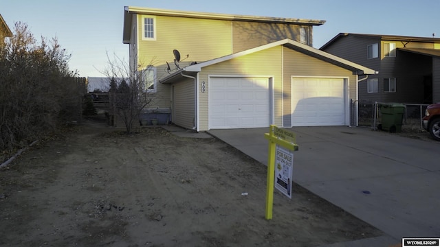 909 Skyline Dr, Douglas, WY 82633 - view of side of home featuring an attached garage and driveway