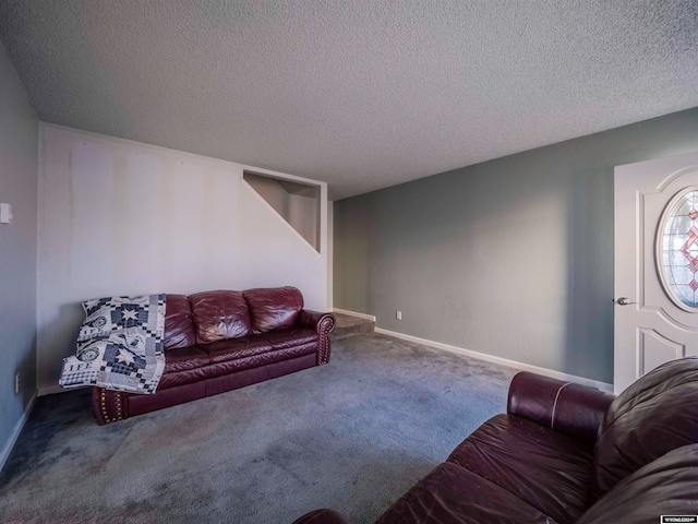 carpeted living room with a textured ceiling and baseboards