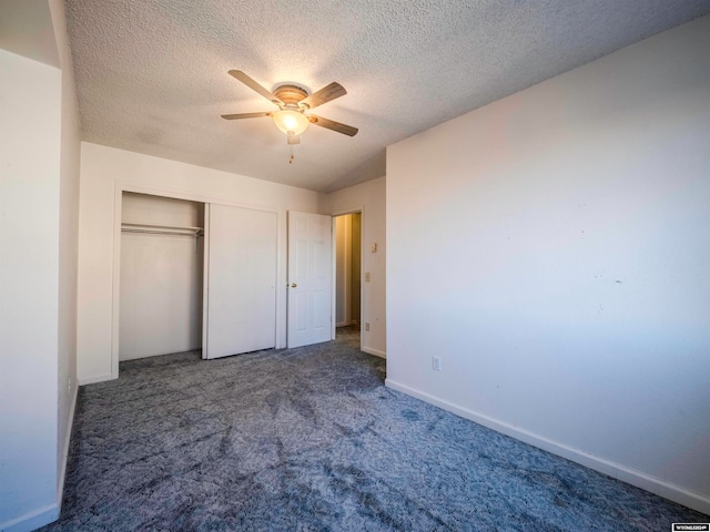 unfurnished bedroom featuring baseboards, ceiling fan, a closet, a textured ceiling, and carpet flooring