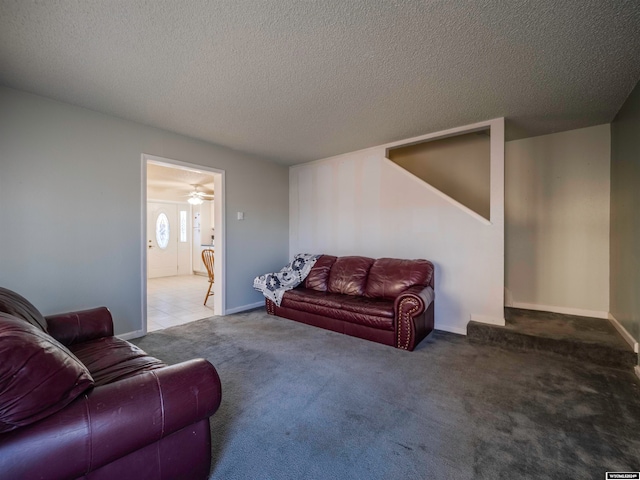 living room with baseboards, a textured ceiling, and carpet flooring