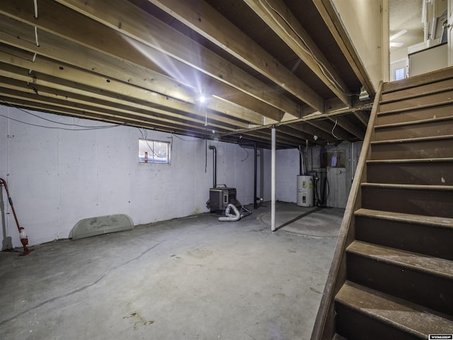909 Skyline Dr, Douglas, WY 82633 - below grade area featuring electric water heater and stairs