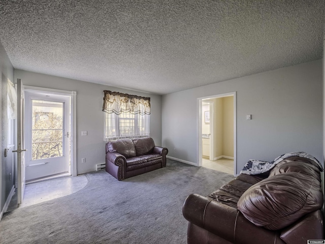 909 Skyline Dr, Douglas, WY 82633 - carpeted living area featuring a baseboard heating unit, baseboards, and a textured ceiling