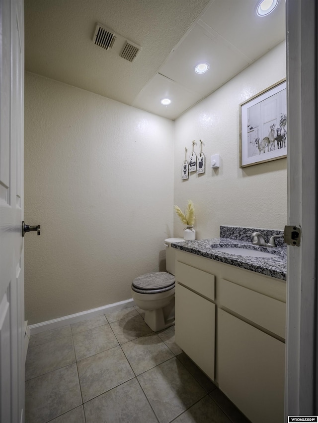 909 Skyline Dr, Douglas, WY 82633 - bathroom with vanity, toilet, recessed lighting, tile patterned floors, and baseboards