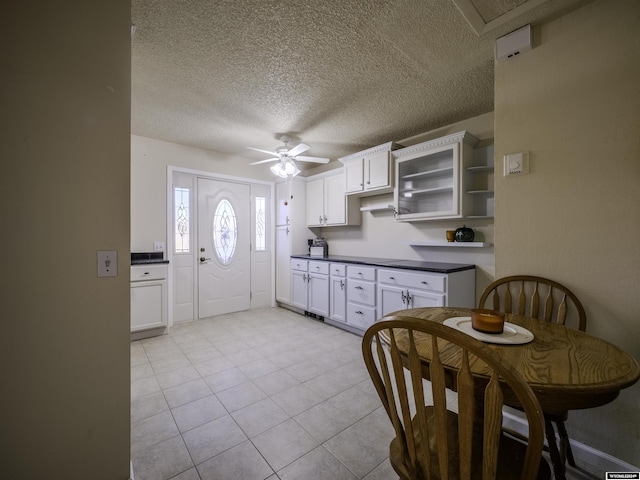 909 Skyline Dr, Douglas, WY 82633 - kitchen with dark countertops, a ceiling fan, white cabinetry, a textured ceiling, and open shelves