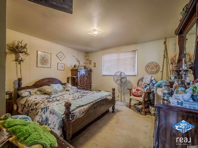 bedroom with a textured ceiling and carpet floors