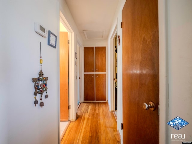 corridor with light hardwood / wood-style floors