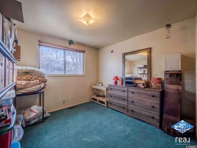 miscellaneous room featuring carpet and a textured ceiling