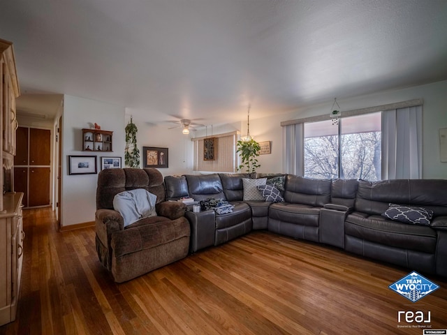 living room featuring hardwood / wood-style flooring and ceiling fan