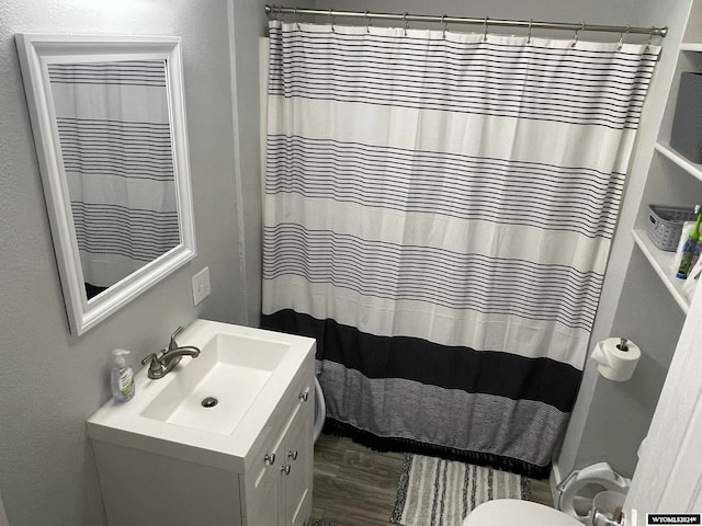 bathroom with vanity and wood-type flooring