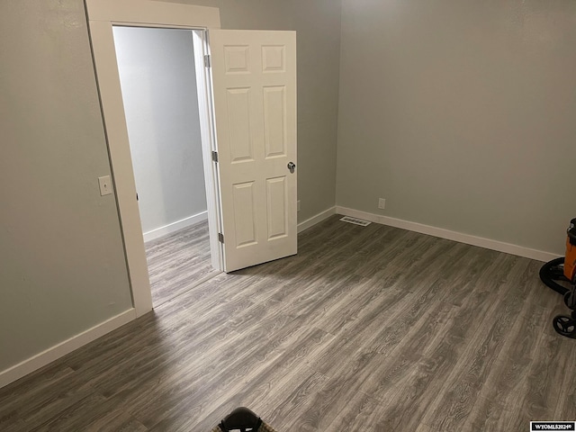 spare room featuring dark wood-type flooring