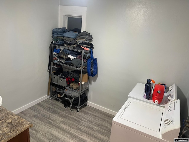 washroom with wood-type flooring and washing machine and clothes dryer