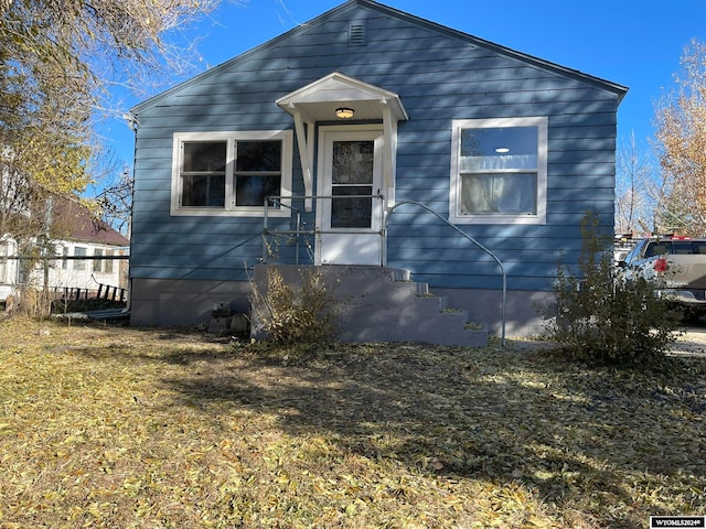 bungalow-style home with a front lawn