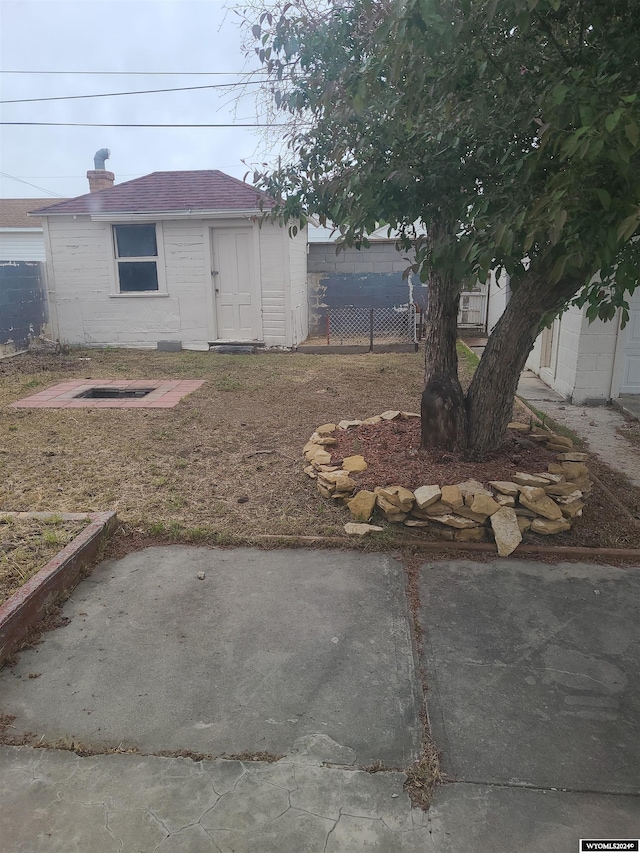 view of yard with a patio and a storage unit