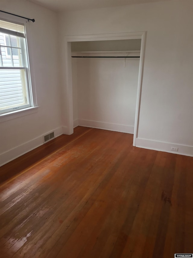 unfurnished bedroom featuring a closet and wood-type flooring