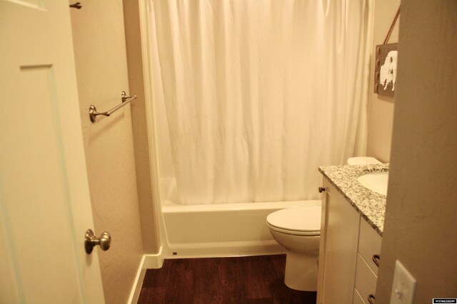 full bathroom featuring shower / tub combo with curtain, vanity, wood-type flooring, and toilet