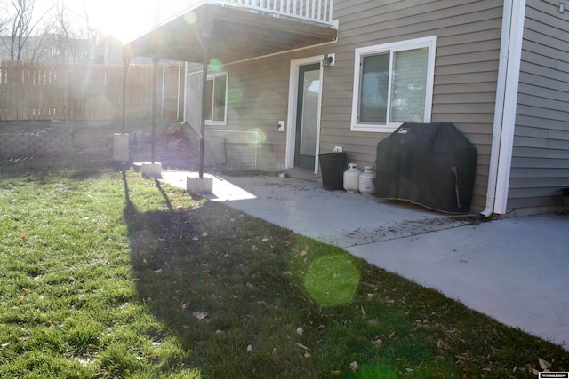 exterior space featuring a balcony, a yard, and a patio