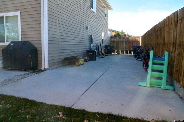 view of property exterior with cooling unit and a patio