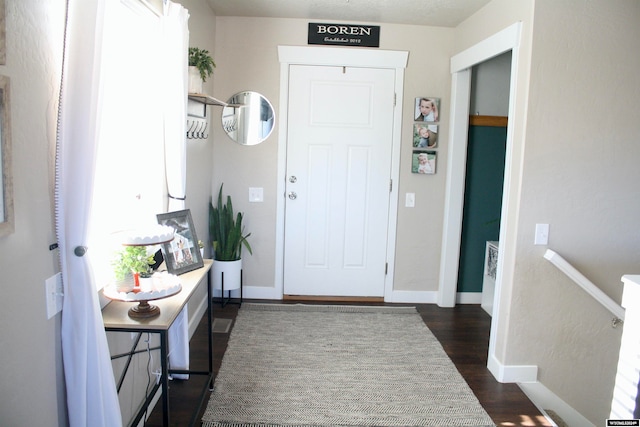 foyer entrance with dark hardwood / wood-style floors