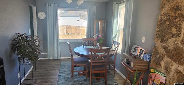 dining room with dark hardwood / wood-style flooring