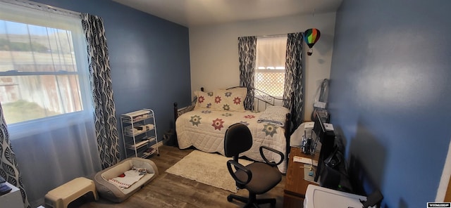 bedroom with dark wood-type flooring