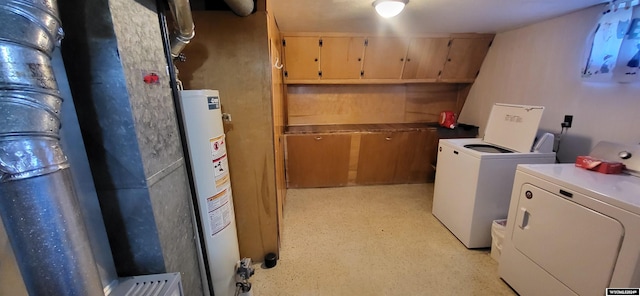 clothes washing area with gas water heater and separate washer and dryer