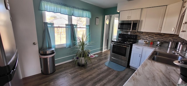 kitchen with white cabinets, decorative backsplash, stainless steel appliances, and dark wood-type flooring